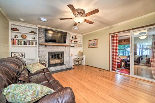 a living room with a couch and a fireplace at Charming Lakefront Home with Grill and Fire Pit! in New Concord