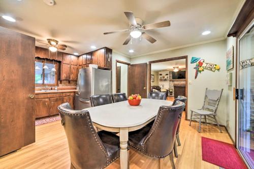 a kitchen and dining room with a table and chairs at Charming Lakefront Home with Grill and Fire Pit! in New Concord