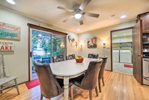 a dining room with a table and chairs at Charming Lakefront Home with Grill and Fire Pit! in New Concord