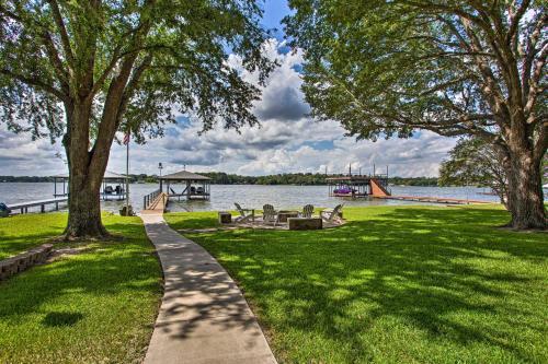 a path in a park next to a body of water at Remodeled Cedar Creek Lake Retreat with Fire Pit! in Malakoff