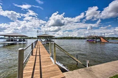 a dock with two boats on a body of water at Remodeled Cedar Creek Lake Retreat with Fire Pit! in Malakoff