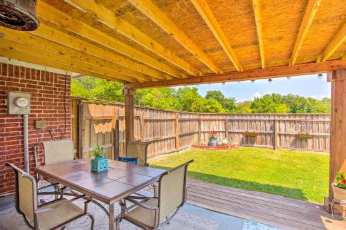 a patio with a wooden pergola with a table and chairs at Family-Friendly Rowlett Home about 23 Mi to Dallas in Rowlett