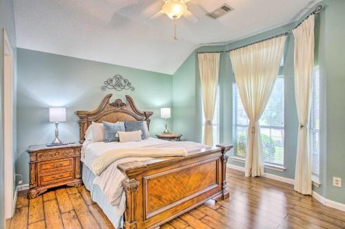 a bedroom with a large bed with a wooden headboard at Family-Friendly Rowlett Home about 23 Mi to Dallas in Rowlett