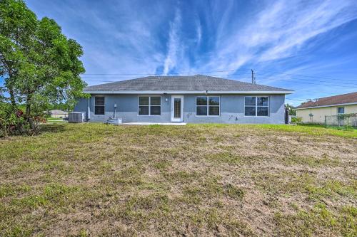 a blue house with a yard in front of it at Ranch-Style Lehigh Acres House with Big Backyard! in Lehigh Acres