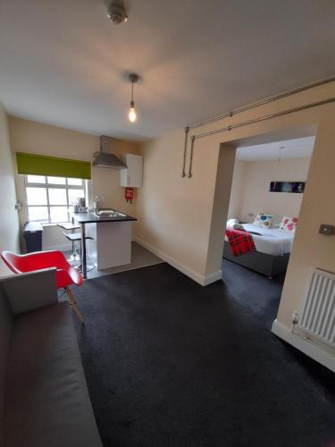 a living room with a kitchen and a bedroom at Potbank in Stoke on Trent