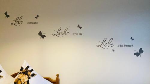a bedroom with butterflies on the wall at gemütliche Wohnung in Bad Schwartau