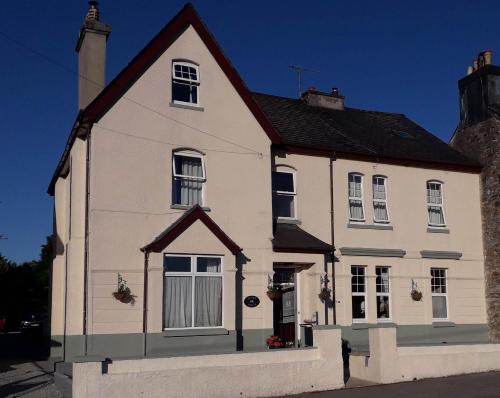 a white house with a black roof at Duchy House Bed and Breakfast in Princetown