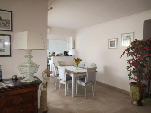 a dining room with a table and chairs at chez MARINO antony real in Orange