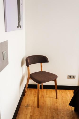 a chair sitting on a wooden floor in a room at Verhovel Hotel in Verkhovyna