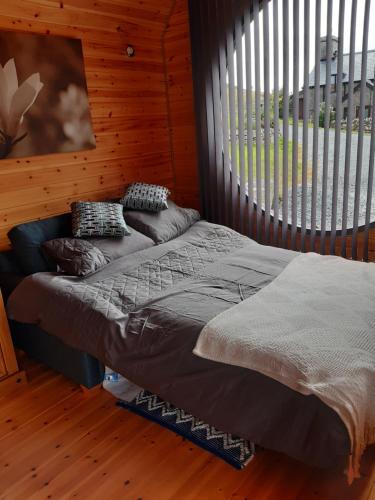 a bed in a room with a large window at Penystryd in Trawsfynydd