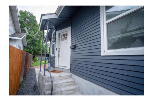 a blue house with a white door and a window at Remodeled Modern 1BR1BA Apt Near Downtown, 5min Pearl in San Antonio