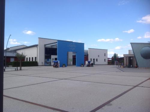 a large building with a blue door in a parking lot at Pension Altstadt Garni in Bad Windsheim