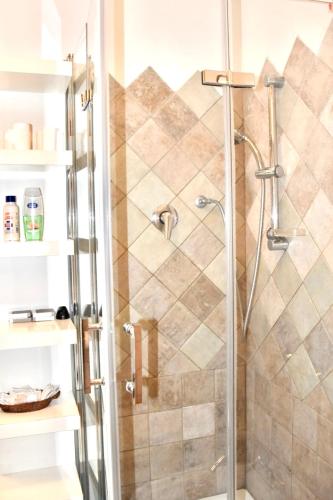 a shower with a glass door in a bathroom at Mansarda Teatro Duse Centro in Bologna