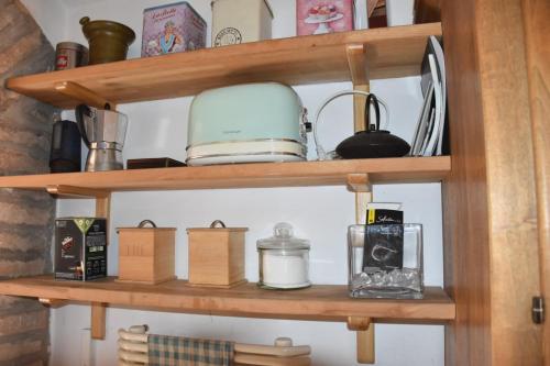 a wooden shelf with various items on it at Mansarda Teatro Duse Centro in Bologna