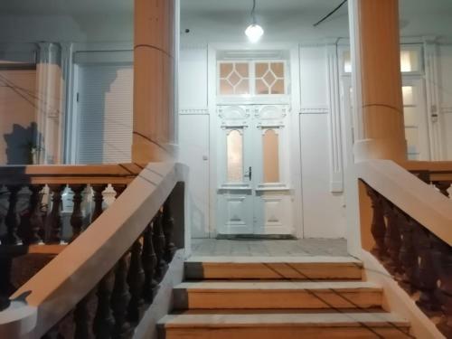 a hallway with stairs with a white door at Guest House Prilep in Prilep