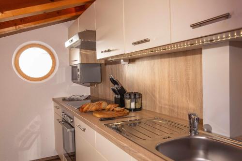 a kitchen with a sink and a counter with bread at Malmurainza in Samnaun