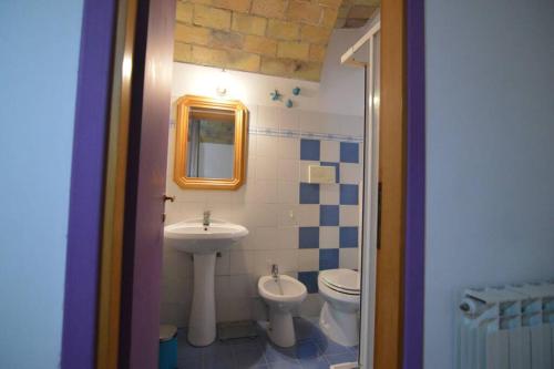 a bathroom with a sink and a toilet and a mirror at La casa della mia famiglia in Rome