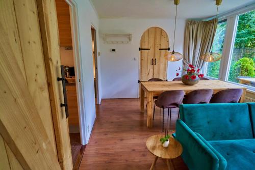 a living room with a blue couch and a table at Boshuisje La Casita - Near Wellness & Golf in Oosterhout