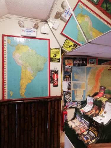 a map hanging on a wall next to a wall at Flying Donkey in Otavalo