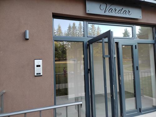 an entrance to a building with a revolving door at Apartman Spas Titova Vila Zlatibor in Palisad
