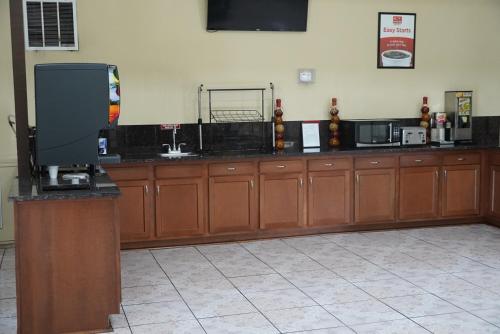 a large room with wooden cabinets and a television at Econo Lodge Jacksonville South in Jacksonville