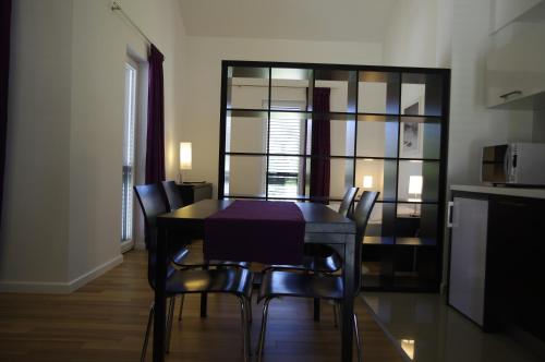 a dining room with a table and chairs at Apartments Santis10 in Baška