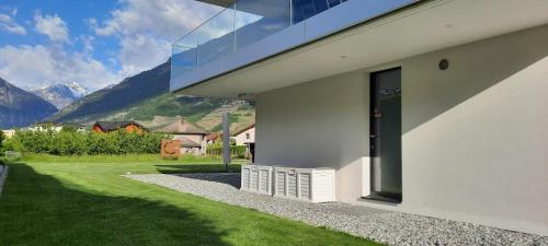 a white house with a view of a mountain at Alps Spirits - B&B Studio in Fully