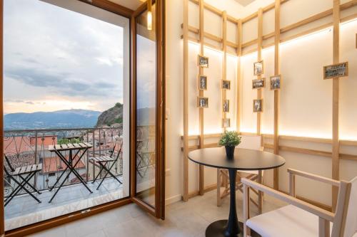 a balcony with a table and a view at Terra del Sasso Suites - Design Architetto Salvatore Spataro in Sasso di Castalda