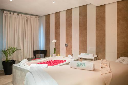 a spa room with a large bed with a spa sign on it at Iberostar Waves Rose Hall Beach - All Inclusive in Montego Bay