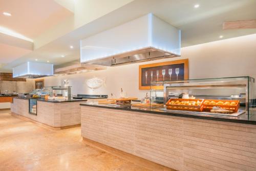 a kitchen with a counter with food on it at Iberostar Waves Rose Hall Beach - All Inclusive in Montego Bay