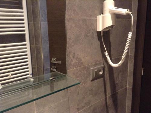 a phone is hanging on a wall in a bathroom at Villa Le Logge in Ventimiglia