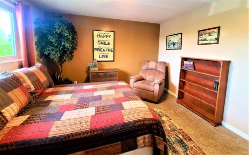 a bedroom with a bed and a chair at Cottonwood Comfort in Salt Lake City