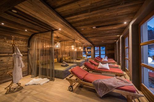 a room with a bunch of beds in it at Helmhotel in San Candido