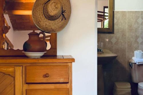 a hat on top of a wooden dresser in a bathroom at Casa Azar in Mazunte