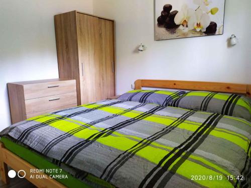 a bedroom with a bed and a wooden dresser at Holiday home in Svahova - Erzgebirge 41640 in Svahová