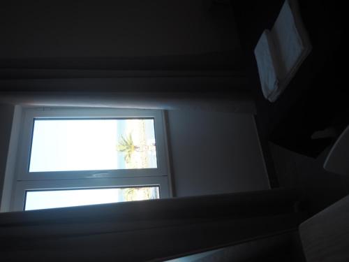 a window in the corner of a room at Casa AUGUSTA in Lagos