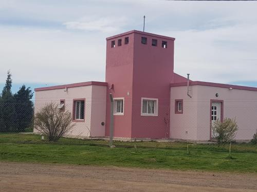 a building with a pink tower on top of it at Las Condalias in Puerto Madryn