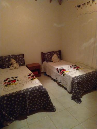 a bedroom with two beds witheddy bears on them at Spazio Farfalla in Itupeva