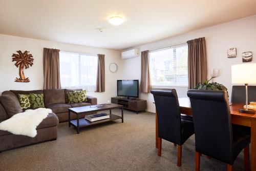 a living room with a couch and a table at Blenheim Palms Motel in Blenheim