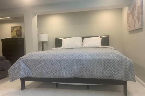 a bedroom with a bed with a blanket and pillows at Cindy's Super Ranch Home in West Chester