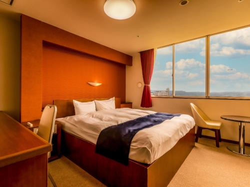 Ένα ή περισσότερα κρεβάτια σε δωμάτιο στο Yukai Resort Saichoraku