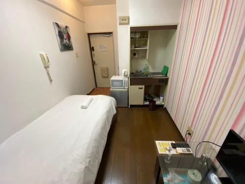 Pokój z łóżkiem, stołem i umywalką w obiekcie Exsaison Shirokita 511 w Osace