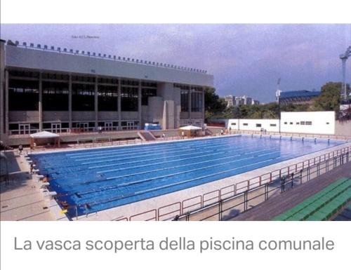 a large swimming pool in front of a building at Federico 70 Smeraldo in Palermo