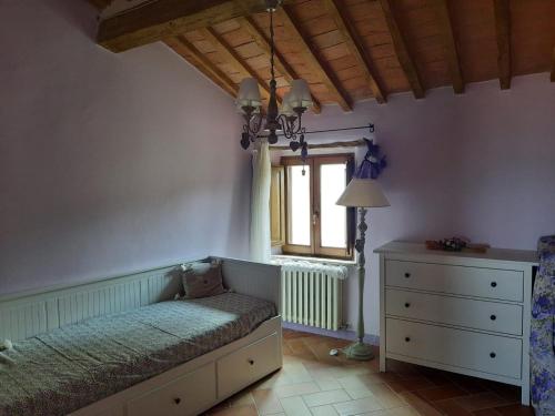 a bedroom with a bed and a window and a dresser at Al Piccolo Ulivo, a casa di Mimo&Sè in Castiglione dʼOrcia