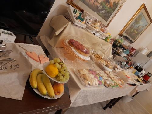 a table topped with plates of fruit and food at Locanda 130 in Fonni