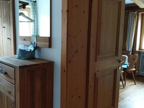 a kitchen with a wooden door and a table at Gästehaus Maier in Kitzbühel