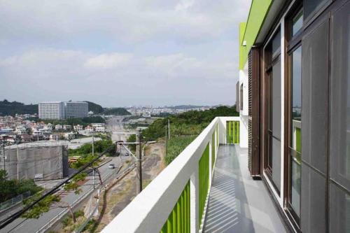 a balcony with a view of a city at Japanestジャパネスト in Tomigusuku