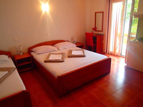 a bedroom with a bed with two certificates on it at Villa Bosac in Gradac