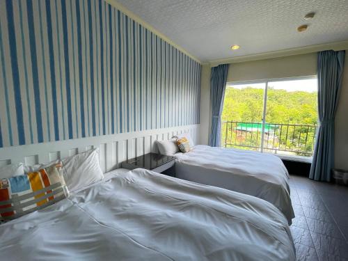Postel nebo postele na pokoji v ubytování 南灣飯店 Kenting Nanwan Hotel