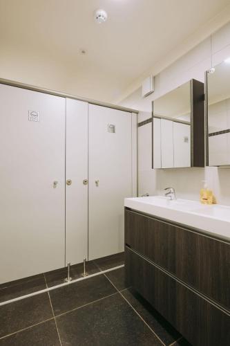 a bathroom with a sink and a large mirror at Vakantiewoning Vennekens in Peer